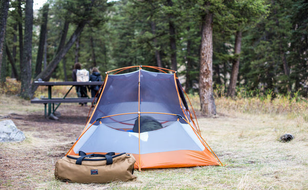 A Yeoman Duffel outside of a camping tent.